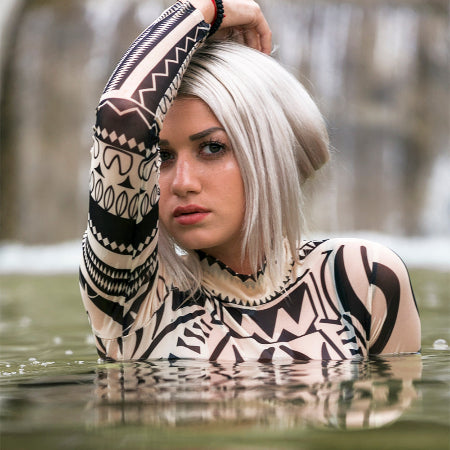 Formal women in a waterfall fountain